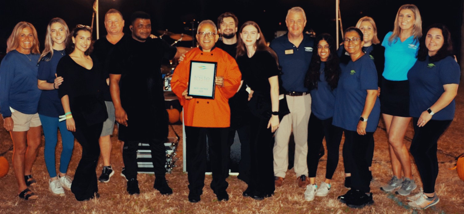 Uday Kadam holding an award from Business Expo 2025 for the best entree award with his team